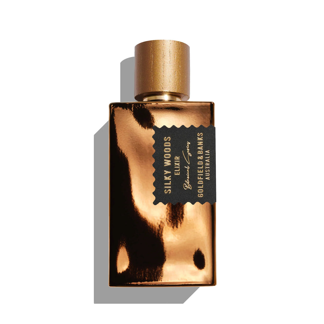 Goldfield & Banks Silky Woods Elixir bottle with vanilla, oud, balsam, saffron, musk, and fig notes on a white background.